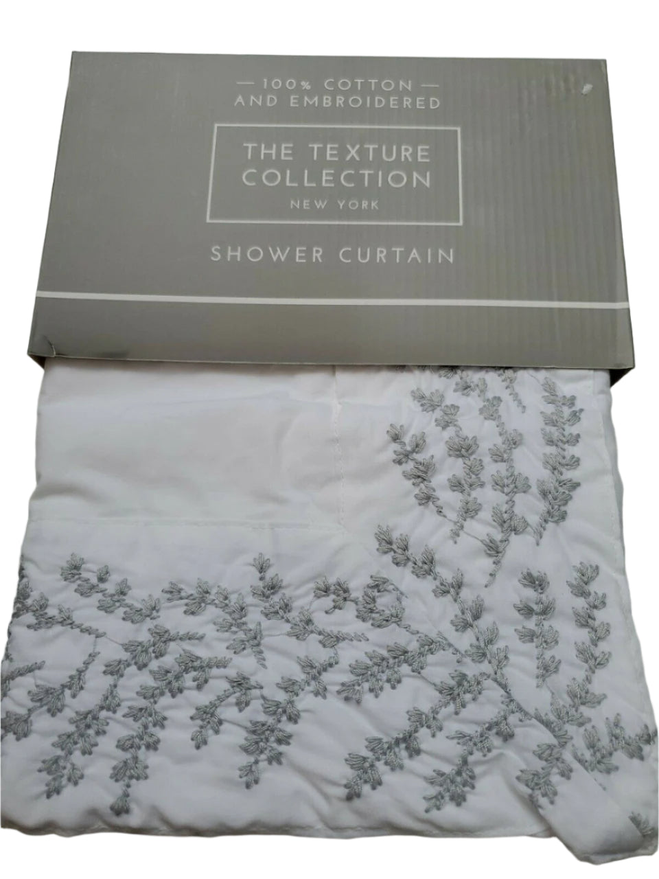Folded white 100% cotton embroidered shower curtain from The Texture Collection shown in retail packaging