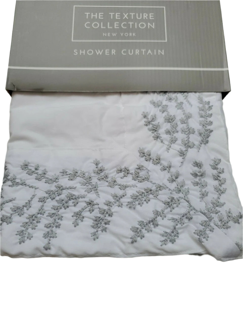 Folded white 100% cotton embroidered shower curtain from The Texture Collection shown in retail packaging