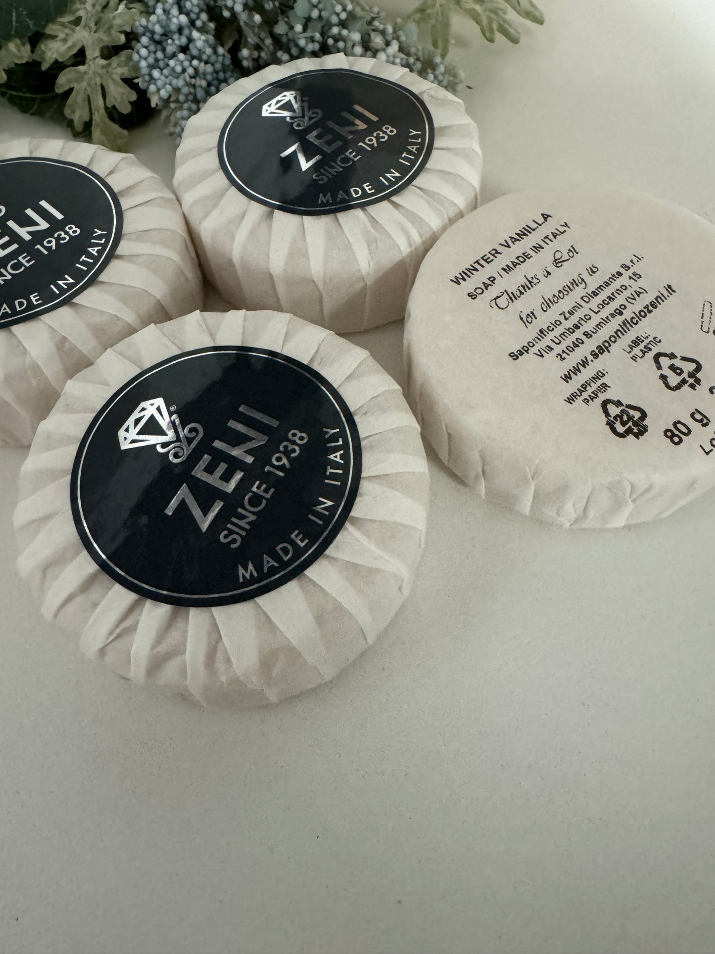 Close-up of Winter Vanilla soap bars with black and white labels, showing details and wrapping
