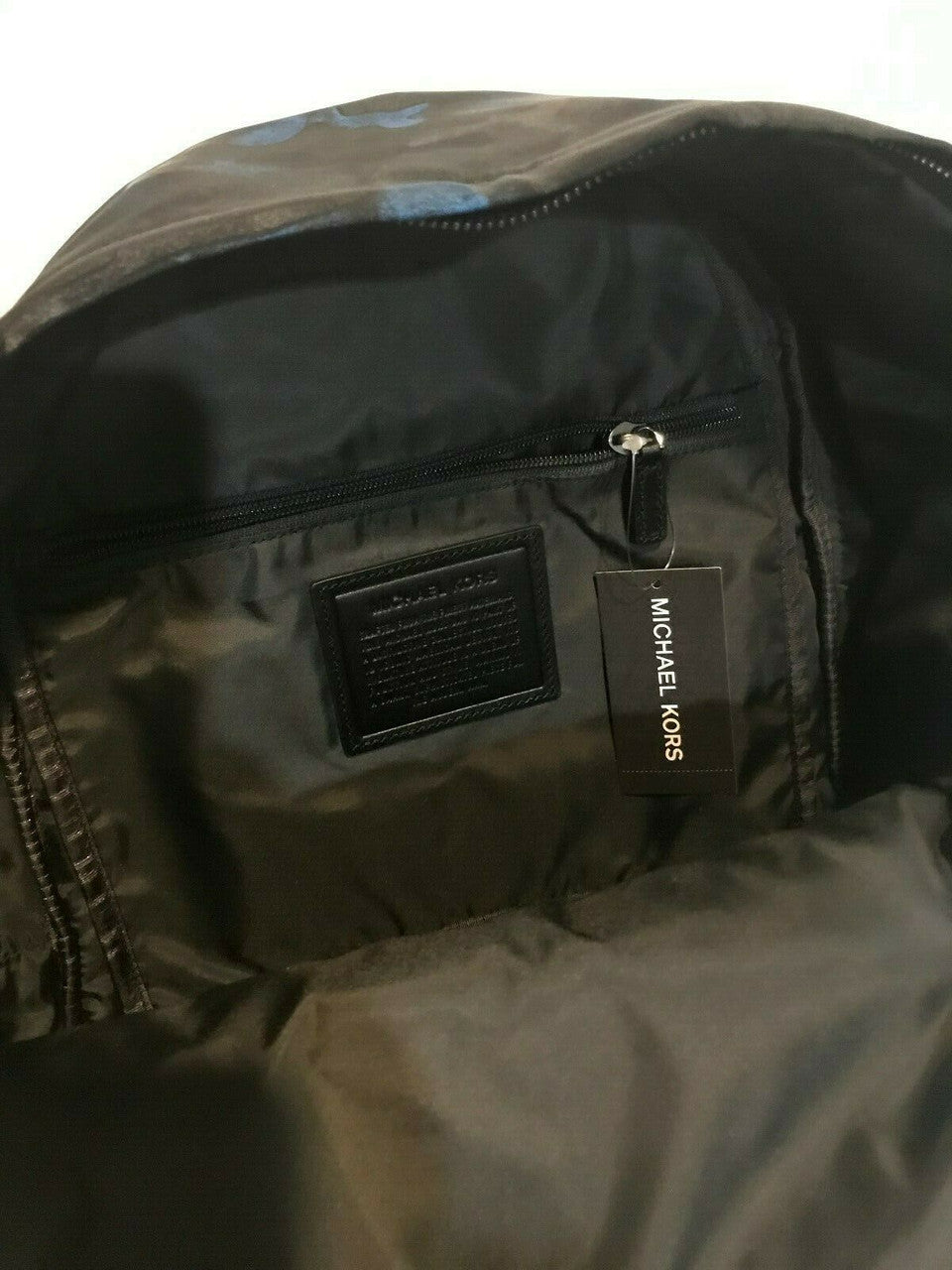 Men’s midnight camo backpack with nylon exterior, leather trim, and padded shoulder straps