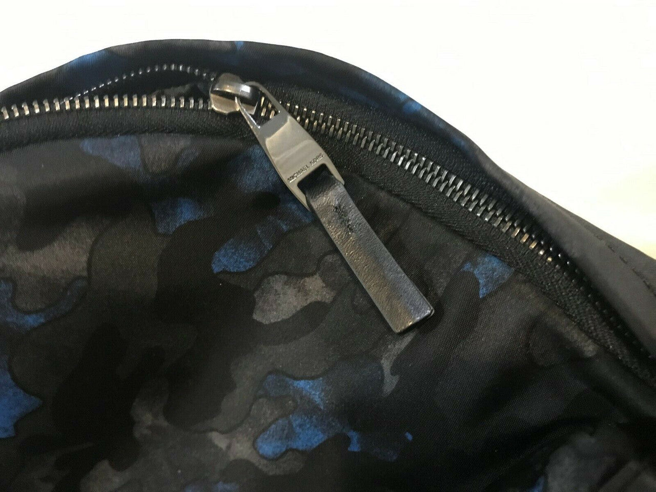 Men’s midnight camo backpack with nylon exterior, leather trim, and padded shoulder straps