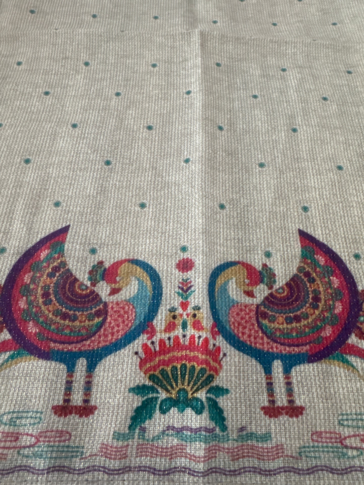 Close-up of a set of 8 vibrant, peacock-themed napkins with intricate lurex and printed designs. Each napkin is elegantly crafted from polyester with metallic fibers, showcasing a festive and luxurious touch with a rich color palette