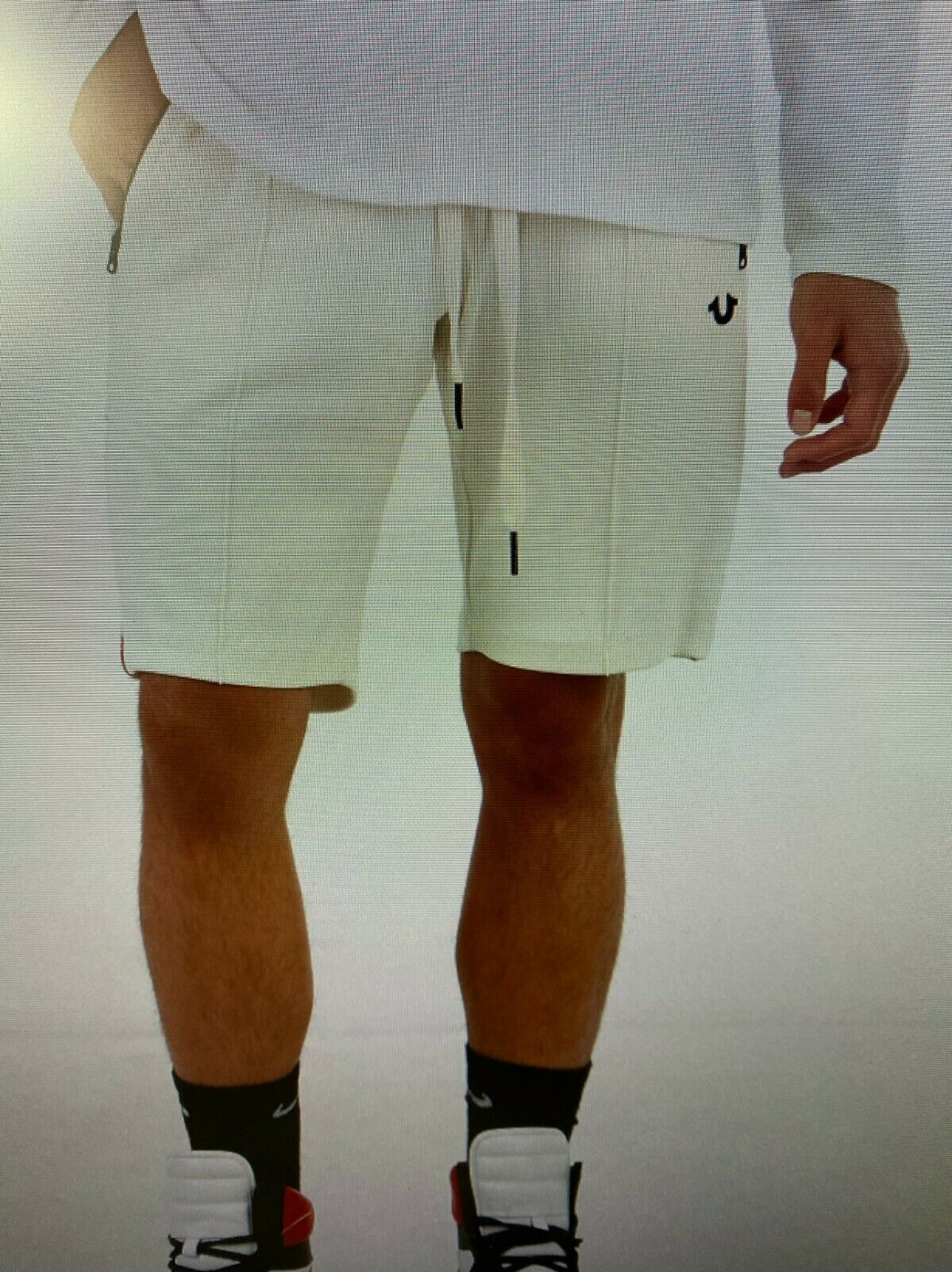 Men’s off-white logo shorts with drawstring waist, zip pockets, and horseshoe logo – shown on model